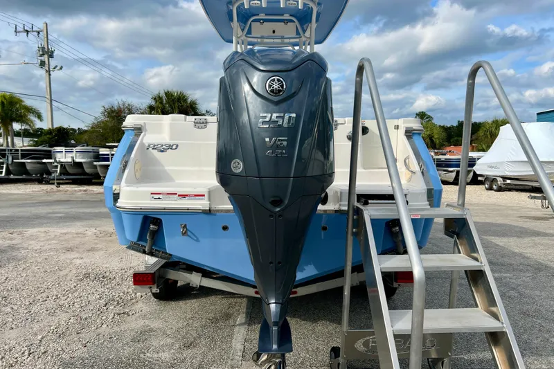 Slide: The Image of 2024 Robalo R230 Center Console boat with Yamaha 250 V6 engine, parked outdoors. - 7