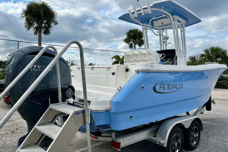 Slide: The Image of 2024 Robalo R230 Center Console boat on trailer, featuring Yamaha outboard motor. - 8