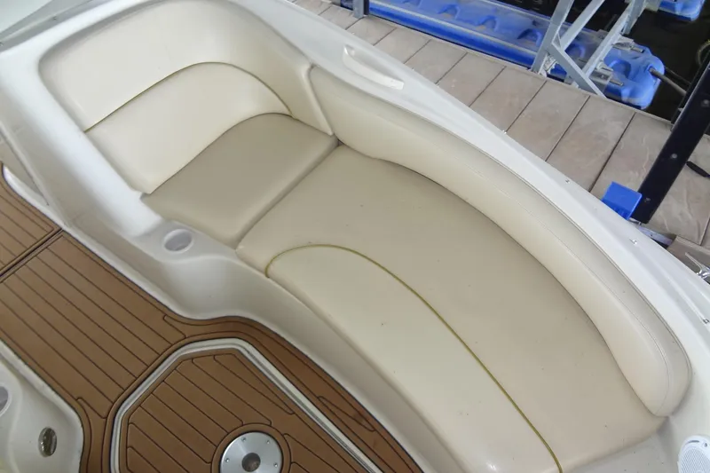 Slide: The Image of Cream leather seating on 2000 Sea Ray 240 Sundeck boat with wooden deck. - 10