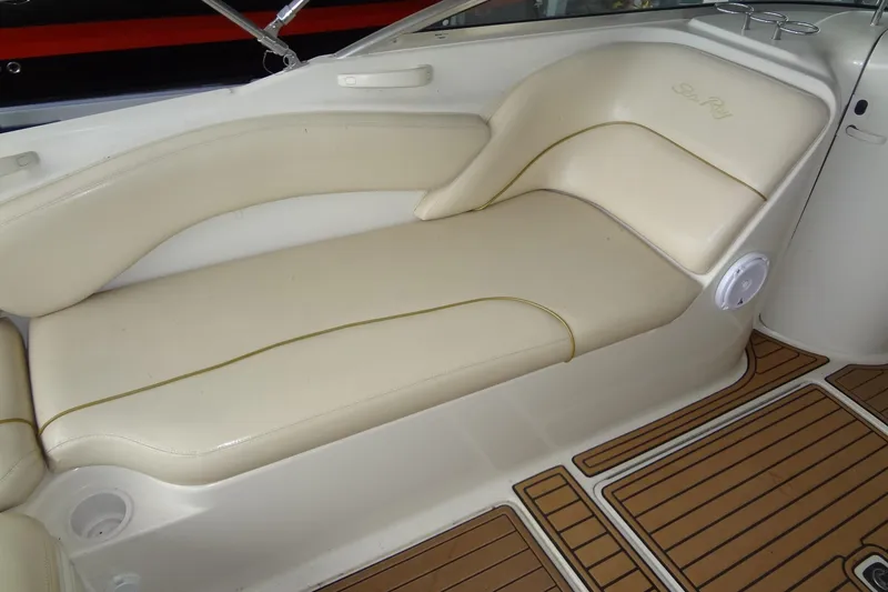 Slide: The Image of Cream leather seating on 2000 Sea Ray 240 Sundeck boat, featuring wood-patterned flooring. - 16