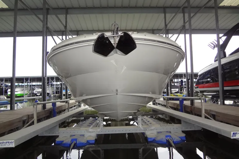 Slide: The Image of 2000 Sea Ray 240 Sundeck on boat lift in marina. - 2