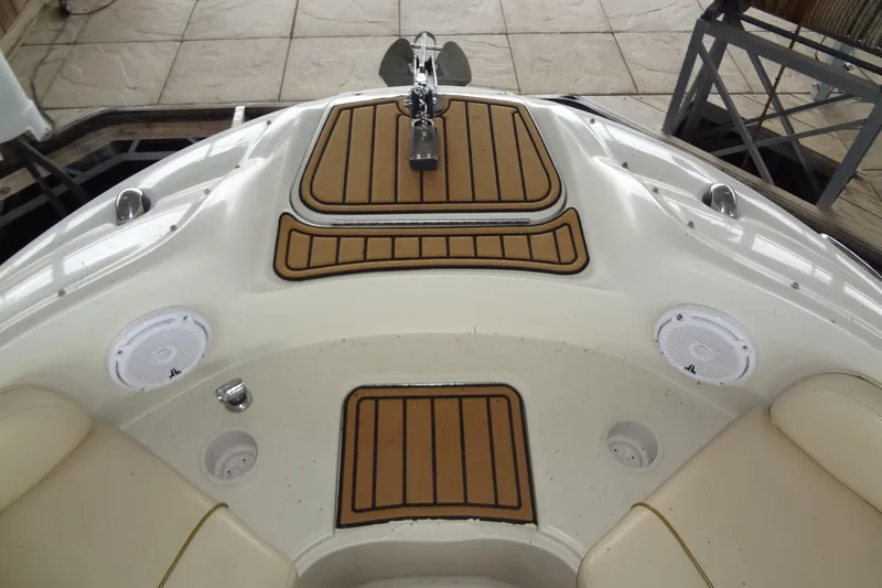 Slide: The Image of 2000 Sea Ray 240 Sundeck boat interior with speakers and teak-style flooring. - 6