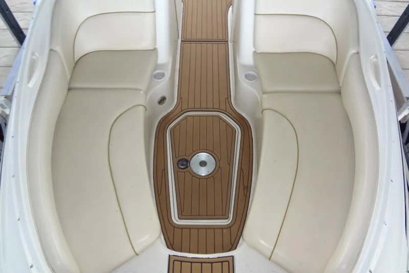 Slide: The Image of Interior view of 2000 Sea Ray 240 Sundeck boat with cushioned seating and wooden flooring. - 7