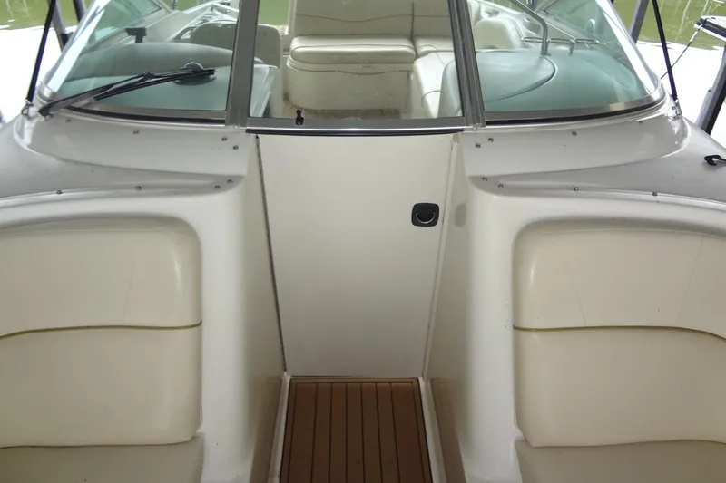 Slide: The Image of 2000 Sea Ray 240 Sundeck interior with seating and windshield view. - 8