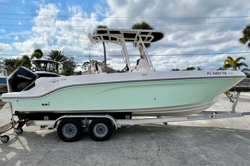 The Image of 2023 Trophy T24CC boat on trailer, featuring sleek design and Mercury engine. - 1