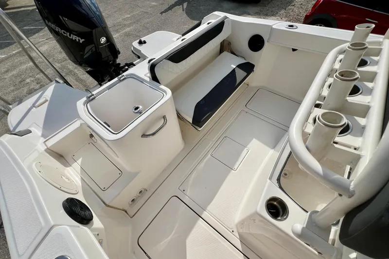 Slide: The Image of 2023 Trophy T24CC boat interior with seating, storage, and Mercury engine. - 10