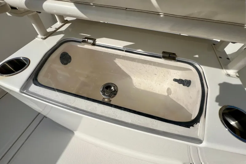 Slide: The Image of 2023 Trophy T24CC boat livewell with transparent lid and cup holders. - 12