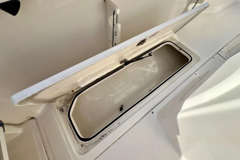 Slide: The Image of Open storage compartment on 2023 Trophy T24CC boat, showcasing interior space. - 14