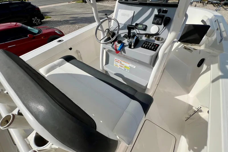 Slide: The Image of 2023 Trophy T24CC boat cockpit with steering wheel, controls, and seating. - 15