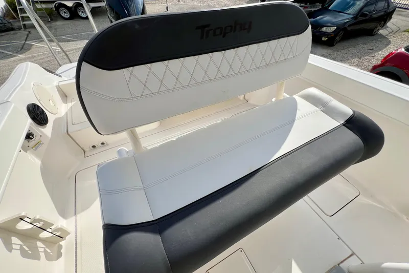 Slide: The Image of 2023 Trophy T24CC boat seat with black and white upholstery, outdoor setting. - 16