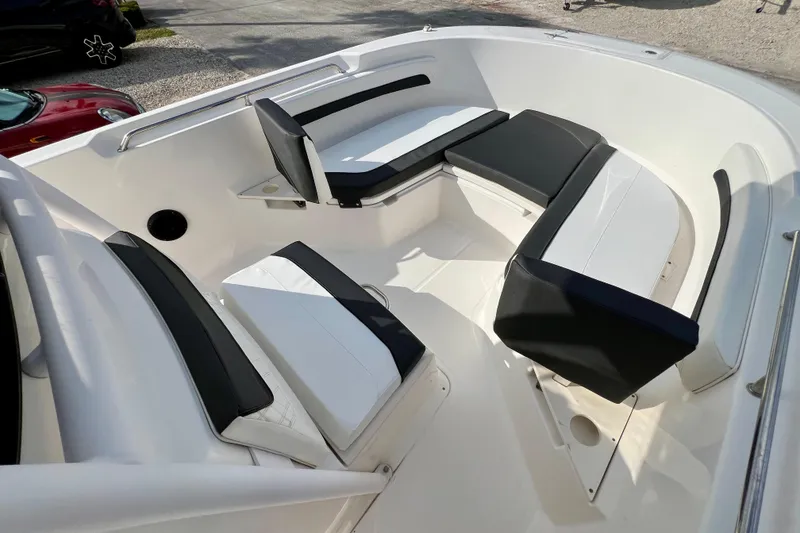 Slide: The Image of 2023 Trophy T24CC boat interior with cushioned seating and sleek design. - 19