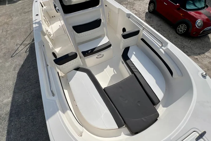 Slide: The Image of 2023 Trophy T24CC boat interior with cushioned seating and sleek design. - 21