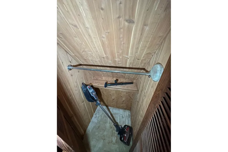 Slide: The Image of Wooden interior of 1986 Bluewater 46 MY with cleaning equipment. - 16