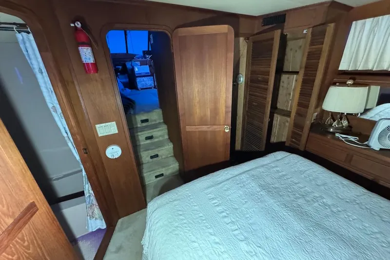 Slide: The Image of Interior of 1986 Bluewater 46 MY yacht, featuring bedroom and stairs. - 19