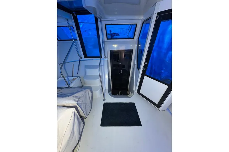 Slide: The Image of Interior of 1986 Bluewater 46 MY yacht with blue-tinted windows and modern design. - 2