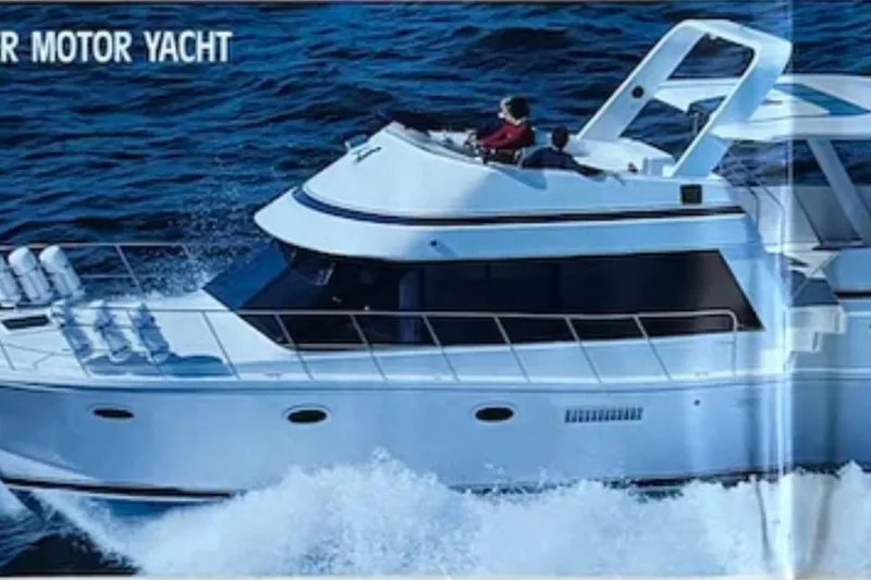 Slide: The Image of 1986 Bluewater 46 MY motor yacht cruising on open water. - 26