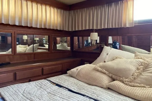 Slide: The Image of Interior of 1986 Bluewater 46 MY yacht with cozy bedroom and elegant wood paneling. - 27