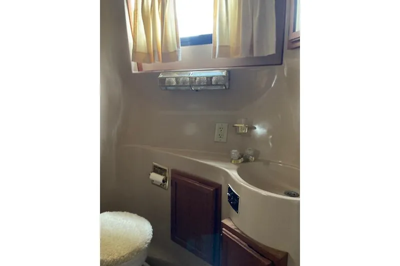 Slide: The Image of Bathroom interior of 1986 Bluewater 46 MY yacht with sink and toilet. - 29