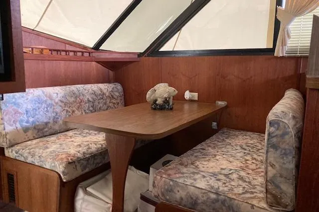 Slide: The Image of Interior of 1986 Bluewater 46 MY yacht with cozy dining area and floral upholstery. - 34