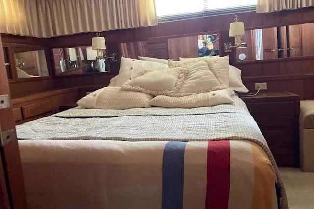 Slide: The Image of Cozy bedroom interior of 1986 Bluewater 46 MY yacht with plush bedding and wooden accents. - 35