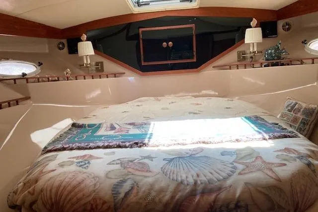 Slide: The Image of Interior of 1986 Bluewater 46 MY yacht with cozy bed and nautical decor. - 5