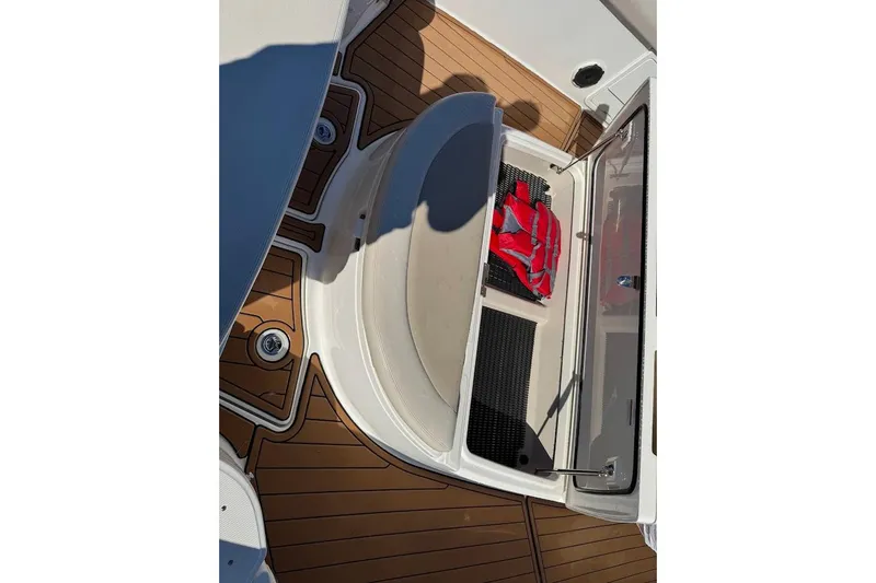 Slide: The Image of 2020 Boston Whaler 420 Outrage boat deck with storage compartment and life jacket. - 16