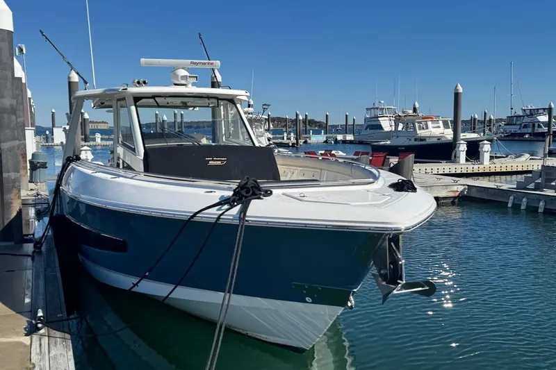 Slide: The Image of 2020 Boston Whaler 420 Outrage docked at marina on a sunny day. - 2