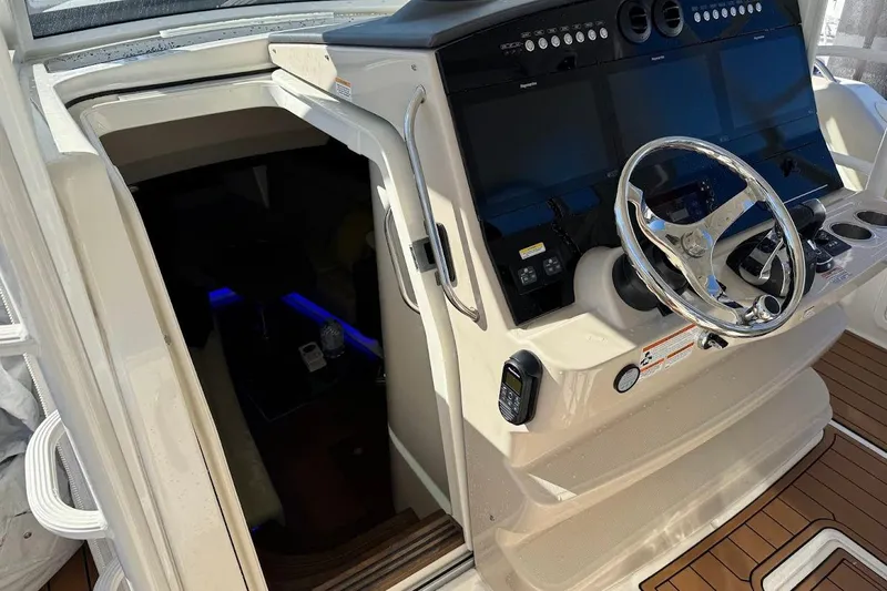 Slide: The Image of 2020 Boston Whaler 420 Outrage helm with advanced navigation systems and sleek steering wheel. - 26