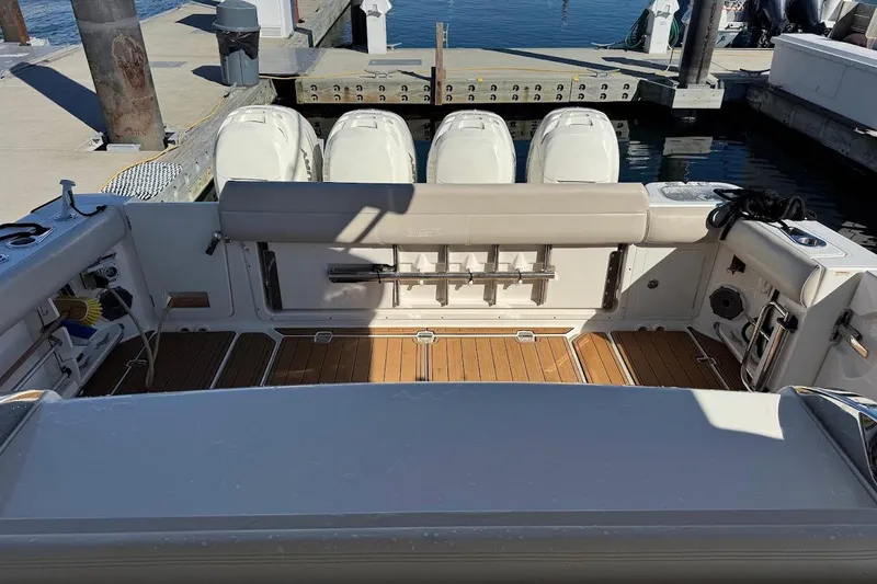 Slide: The Image of 2020 Boston Whaler 420 Outrage boat interior with wooden deck and outboard engines. - 27
