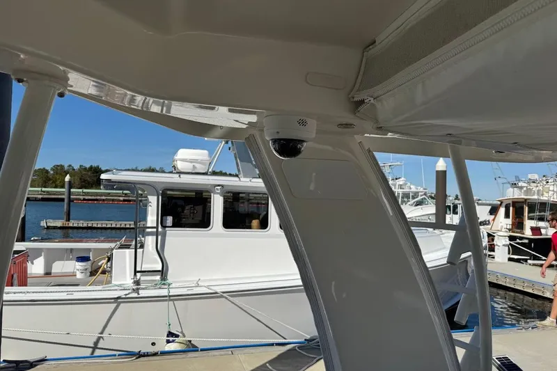 Slide: The Image of 2020 Boston Whaler 420 Outrage docked, featuring interior view and nearby boats. - 34