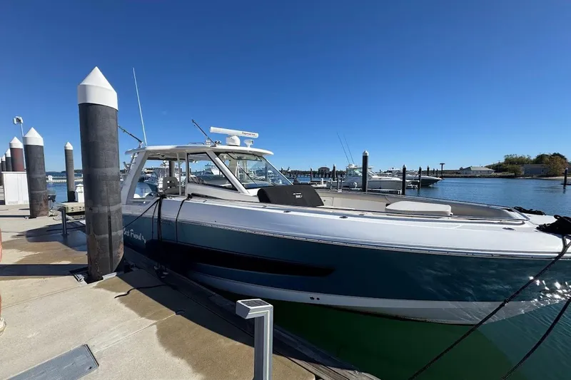 Slide: The Image of 2020 Boston Whaler 420 Outrage docked at a marina under clear blue skies. - 38