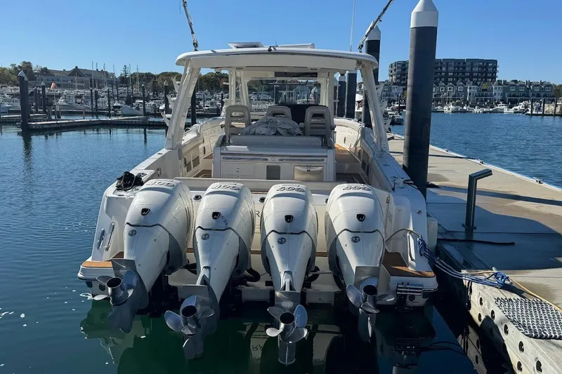 Slide: The Image of 2020 Boston Whaler 420 Outrage with four engines docked at marina. - 5
