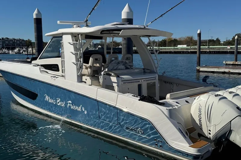 Slide: The Image of 2020 Boston Whaler 420 Outrage boat docked, named "Man's Best Friend." - 6