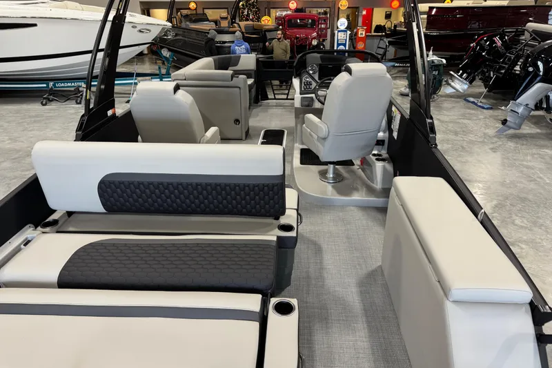Slide: The Image of 2026 Sylvan L-5 Platinum boat interior with modern seating and control console. - 11