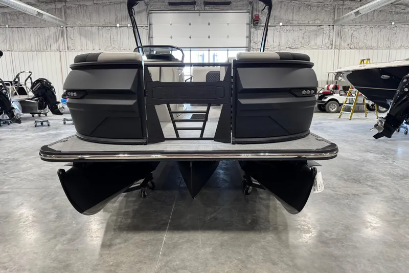 Slide: The Image of 2026 Sylvan L-5 Platinum pontoon boat in a showroom, rear view. - 3