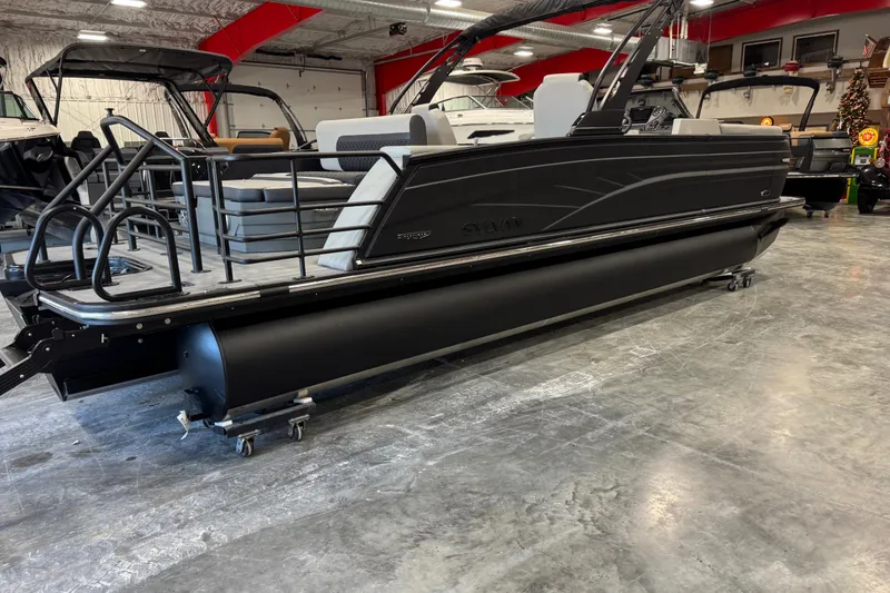Slide: The Image of 2026 Sylvan L-5 Platinum pontoon boat in showroom, sleek black design, modern features. - 4