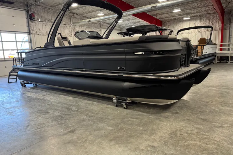 Slide: The Image of 2026 Sylvan L-5 Platinum pontoon boat in a showroom, showcasing sleek design and modern features. - 5