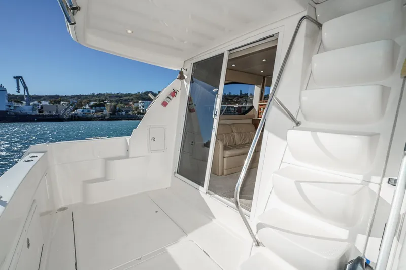 Slide: The Image of 2005 Meridian 381 Sedan yacht deck with stairs and waterfront view. - 11