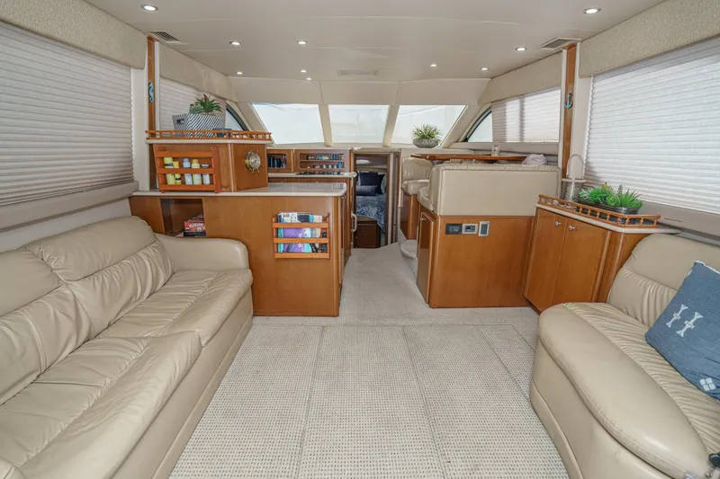 Slide: The Image of Luxurious interior of 2005 Meridian 381 Sedan yacht with beige leather seating and wooden cabinetry. - 12