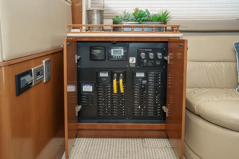 Slide: The Image of Electrical panel inside 2005 Meridian 381 Sedan yacht, featuring control switches and meters. - 18