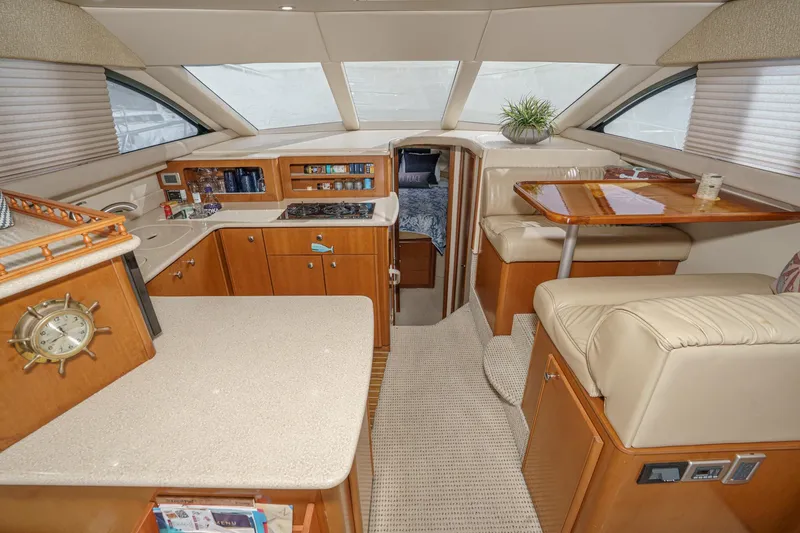 Slide: The Image of Luxurious interior of a 2005 Meridian 381 Sedan yacht with kitchen and seating area. - 19