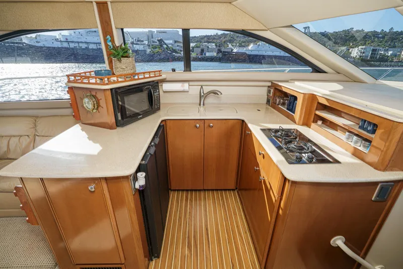 Slide: The Image of Luxurious 2005 Meridian 381 Sedan yacht kitchen with wood cabinetry and modern appliances. - 22