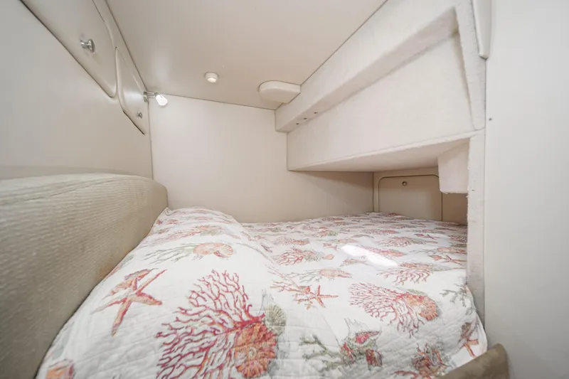 Slide: The Image of Cozy cabin bed in 2005 Meridian 381 Sedan with nautical-themed bedding. - 27