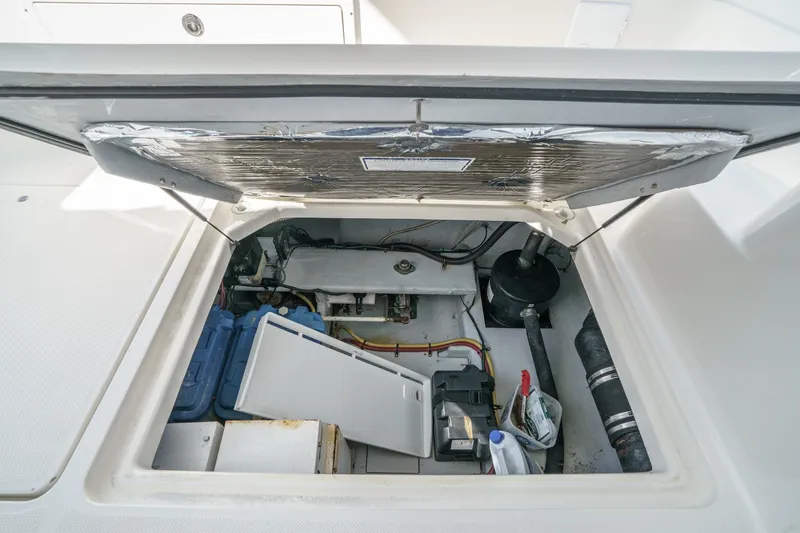 Slide: The Image of Engine compartment of 2005 Meridian 381 Sedan boat, showing mechanical components and storage. - 30