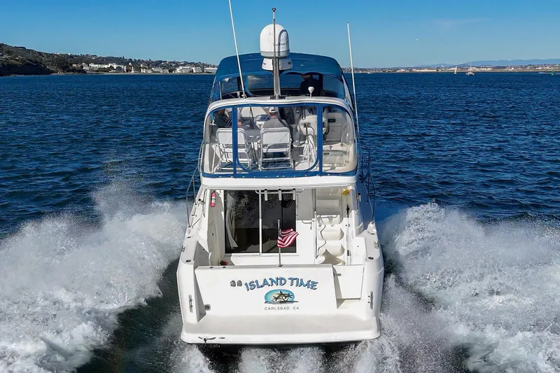 Slide: The Image of 2005 Meridian 381 Sedan yacht cruising on open water, rear view. - 4