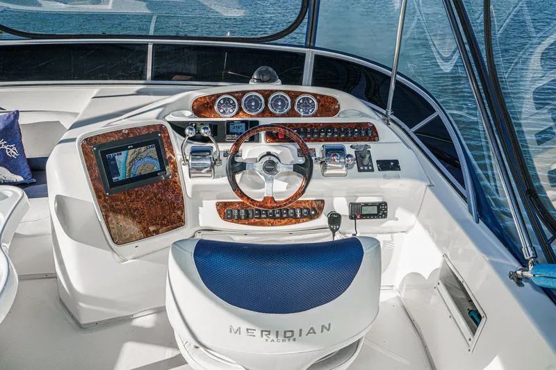 Slide: The Image of Cockpit of 2005 Meridian 381 Sedan yacht with navigation controls and steering wheel. - 6