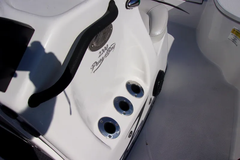 Slide: The Image of 2018 Blue Wave 2200 PureBay boat interior with rod holders and branding. - 14