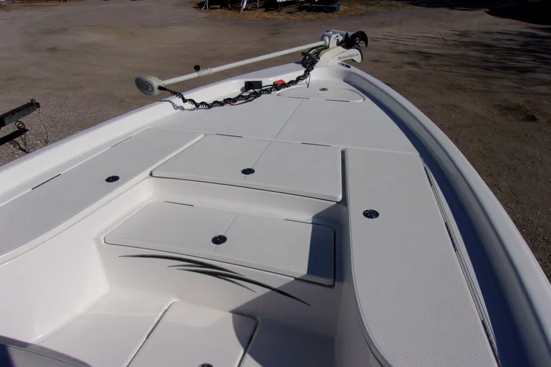 Slide: The Image of 2018 Blue Wave 2200 PureBay boat deck with storage compartments and trolling motor. - 15