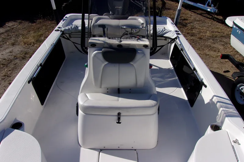 Slide: The Image of 2018 Blue Wave 2200 PureBay boat interior with seating and steering console. - 16