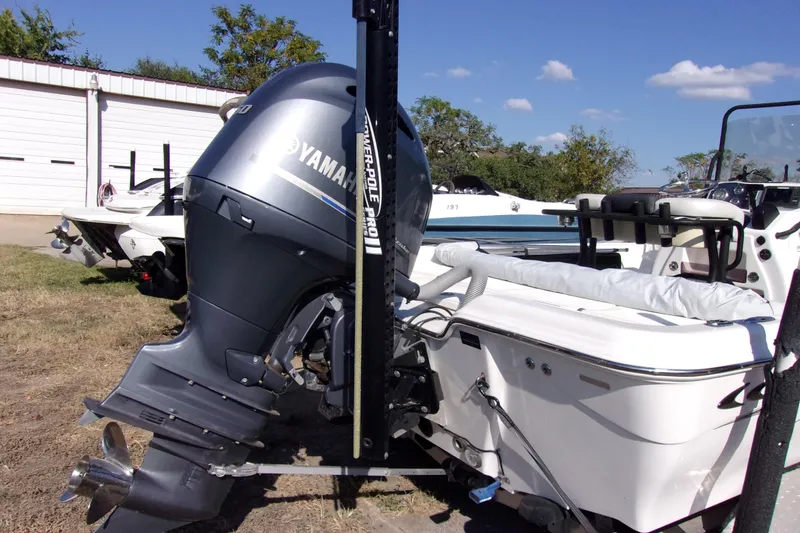 Slide: The Image of 2018 Blue Wave 2200 PureBay boat with Yamaha outboard motor, parked outdoors. - 4
